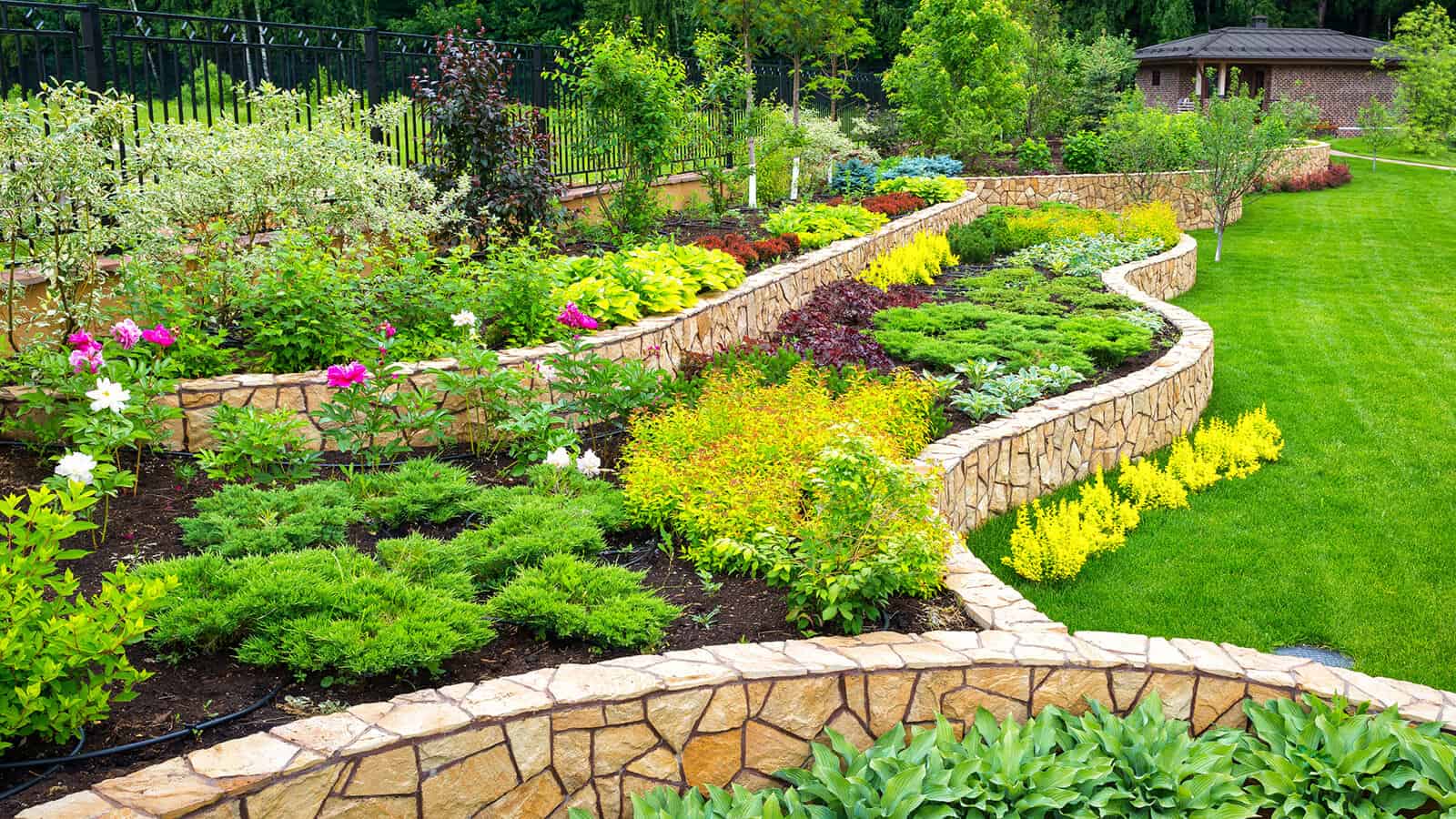 full flower beds and retaining wall