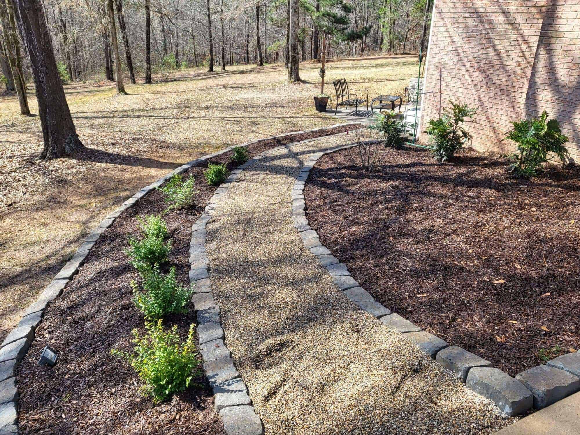 pebble walkway with landscaping beds